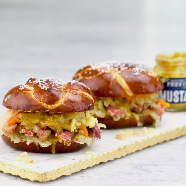 Corned beef and cabbage sandwich on a soft pretzel roll